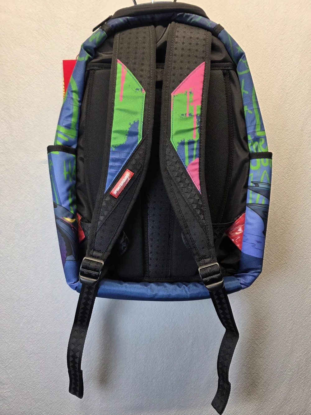 Sprayground DC Joker No Rules Backpack featuring a vibrant, graffiti-styled Bag